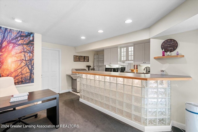 bar featuring dark colored carpet and gray cabinets