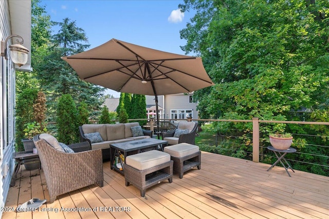 wooden terrace with an outdoor living space