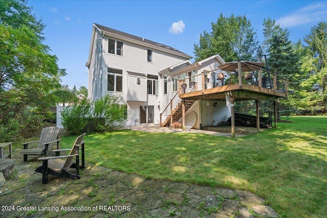 rear view of house featuring a lawn, a patio, and a deck