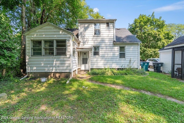 rear view of property featuring a yard