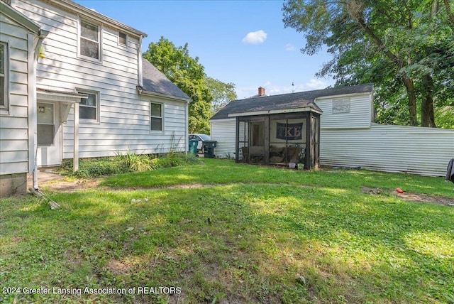 view of yard featuring a sunroom