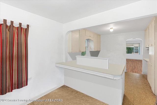 kitchen with cream cabinets and light hardwood / wood-style floors