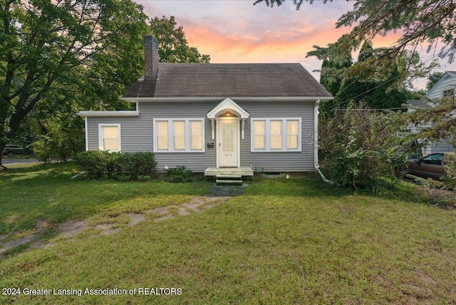 view of front of house with a yard