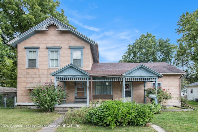 view of front of house with a porch and a front lawn