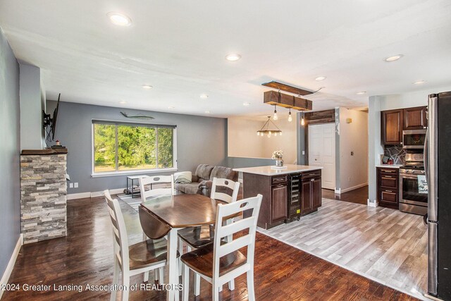 dining room featuring wine cooler and dark hardwood / wood-style floors