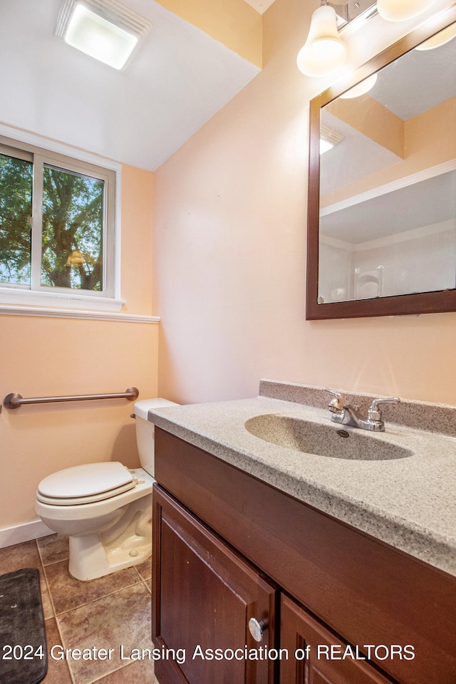 bathroom featuring vanity, toilet, and tile patterned floors