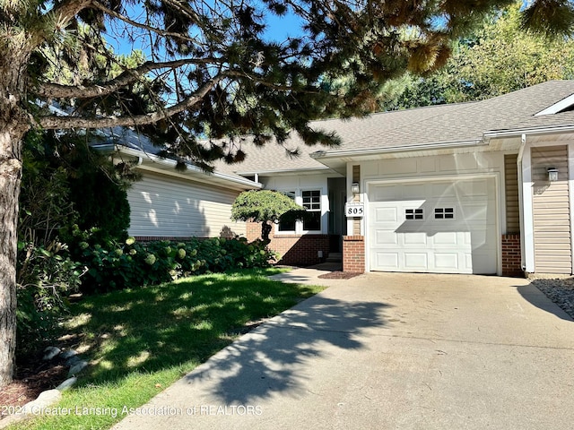 view of front of home with a front yard and a garage