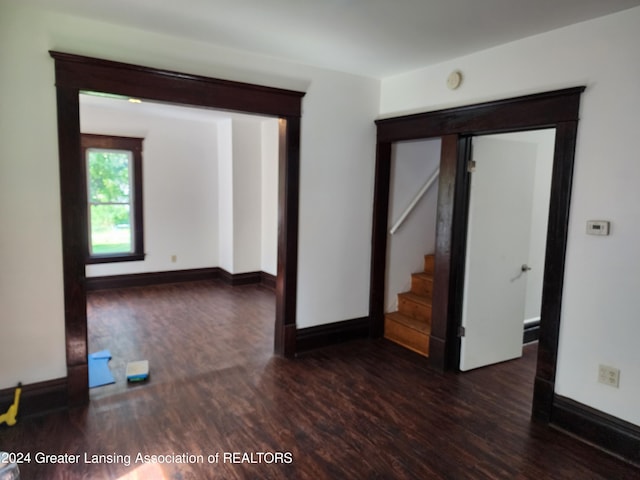 empty room with dark wood-type flooring