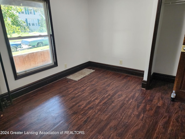 unfurnished bedroom featuring dark hardwood / wood-style floors and a closet