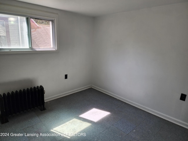 spare room featuring radiator