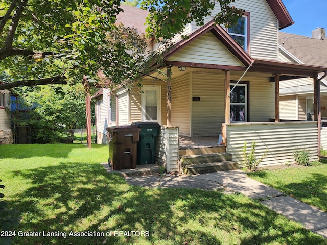 bungalow-style house with a front yard and a porch