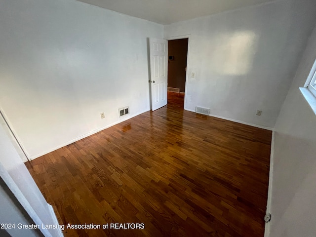 spare room featuring dark hardwood / wood-style flooring