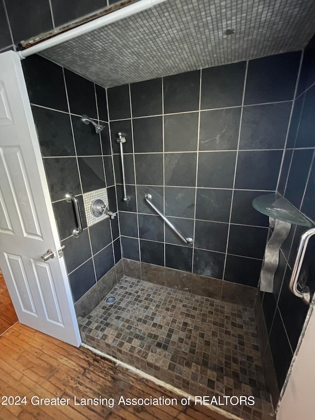 bathroom featuring hardwood / wood-style flooring and an enclosed shower