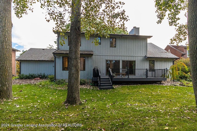 back of house featuring a wooden deck and a yard