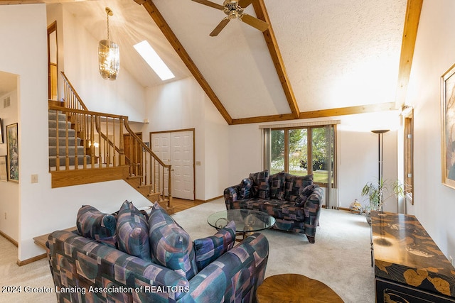 carpeted living room with high vaulted ceiling, ceiling fan with notable chandelier, a textured ceiling, beam ceiling, and a skylight