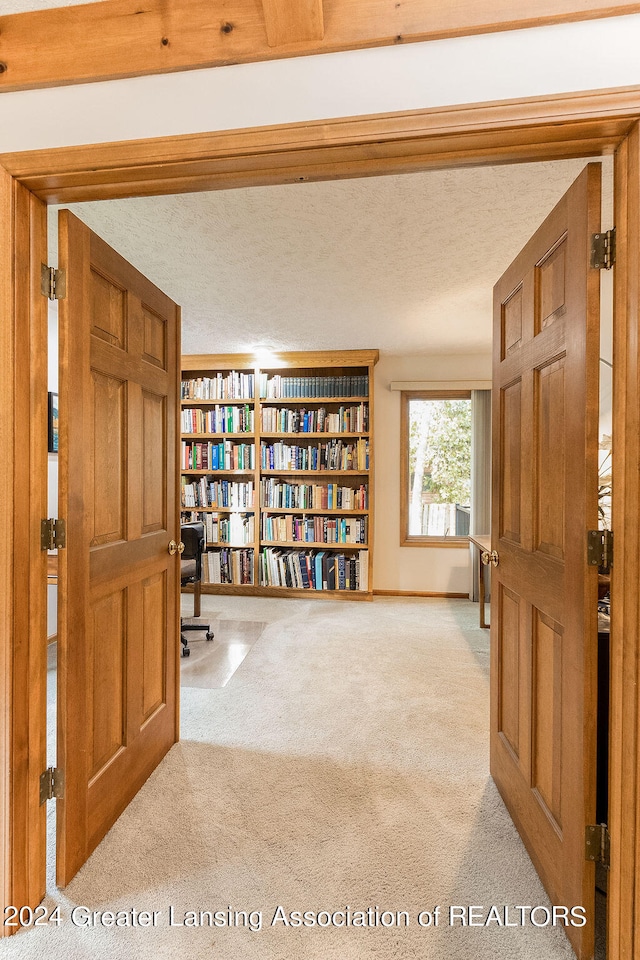 carpeted entryway featuring a textured ceiling