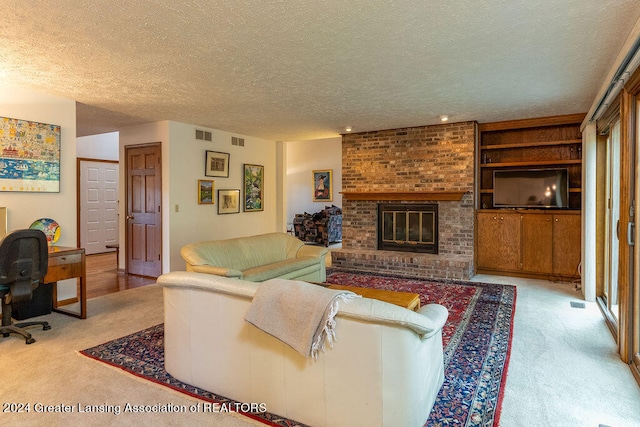 carpeted living room with a brick fireplace and a textured ceiling