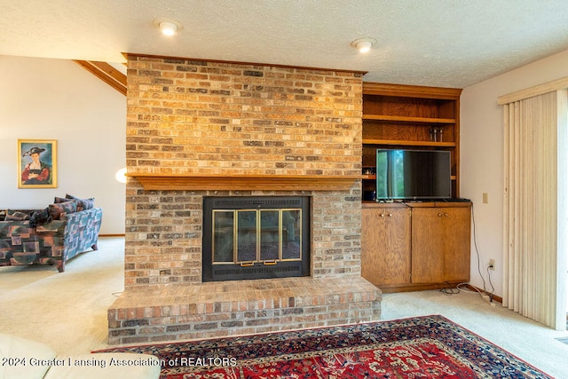 carpeted living room featuring built in shelves, vaulted ceiling, a textured ceiling, and a fireplace