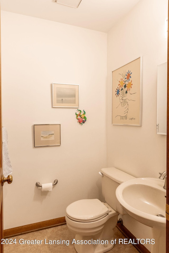 bathroom featuring tile patterned floors and toilet