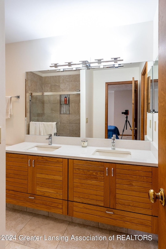 bathroom featuring vanity, tile patterned flooring, and a shower with door