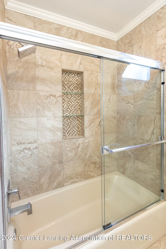 bathroom featuring ornamental molding and combined bath / shower with glass door