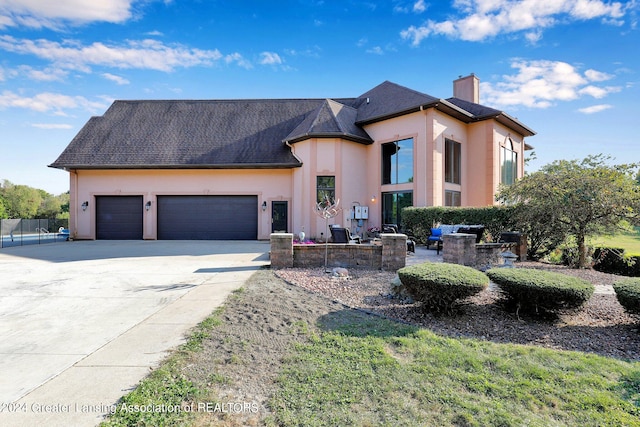 french provincial home with a garage