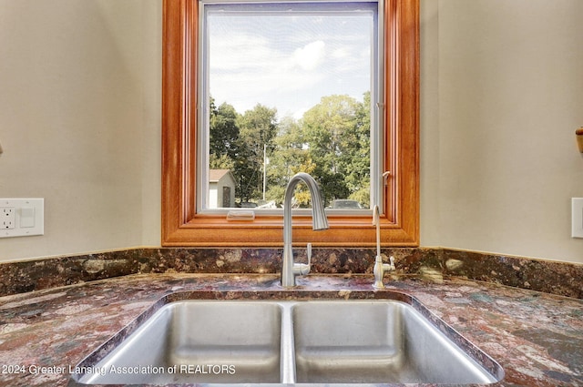 room details with dark stone countertops and sink