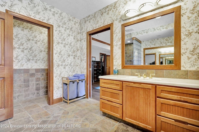 bathroom with vanity and a textured ceiling