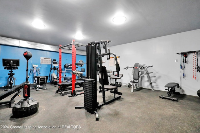 exercise room featuring a wall mounted AC