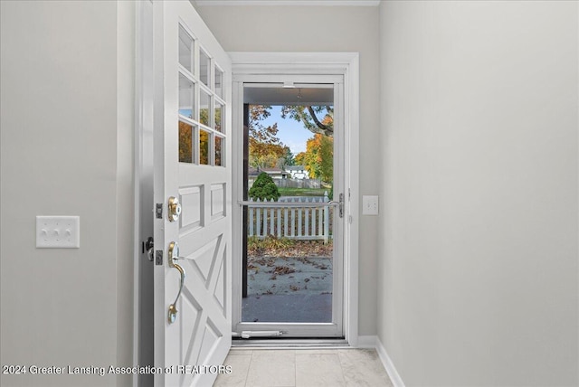 doorway to outside featuring light tile patterned floors