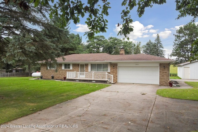 ranch-style home with a garage, a porch, and a front lawn