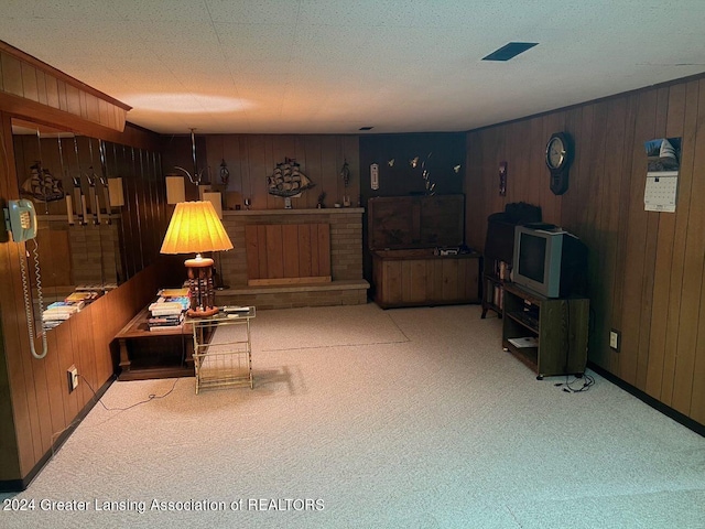 living room with light carpet and wood walls