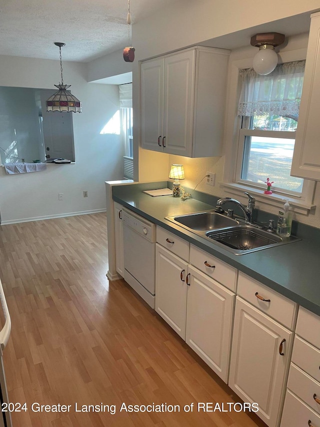 kitchen with light hardwood / wood-style floors, dishwasher, sink, and white cabinets