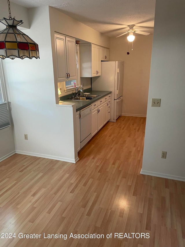 kitchen with white cabinets, white appliances, light wood-type flooring, ceiling fan, and sink