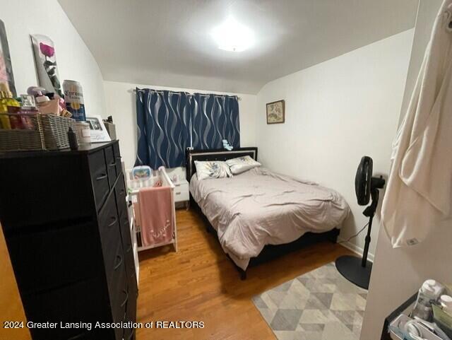 bedroom featuring wood-type flooring and lofted ceiling