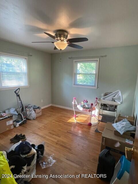 misc room featuring ceiling fan and wood-type flooring