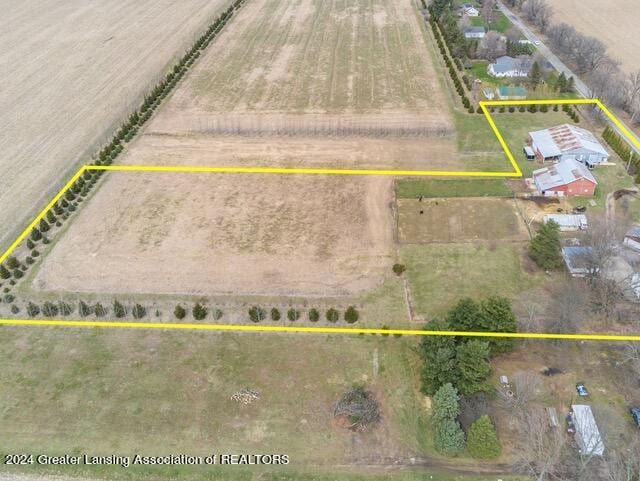 birds eye view of property with a rural view