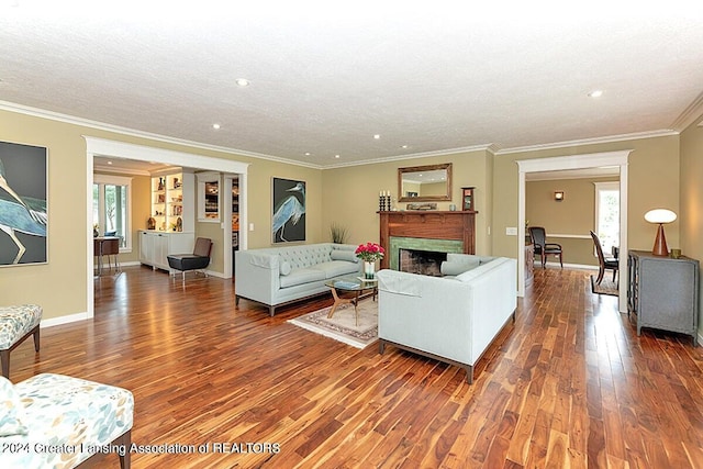 living room featuring ornamental molding, a textured ceiling, and dark hardwood / wood-style flooring