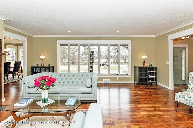 living room with hardwood / wood-style flooring, crown molding, and a textured ceiling