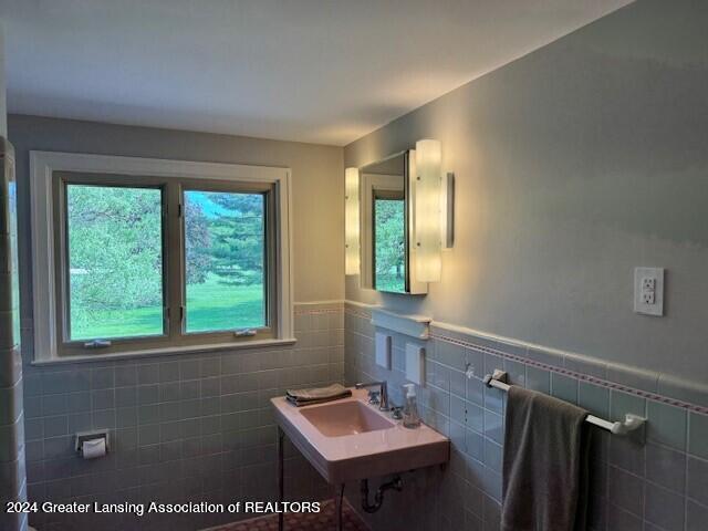 bathroom with tile walls