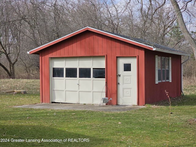 garage featuring a lawn