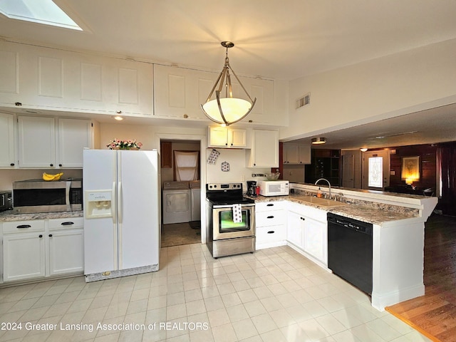 kitchen featuring sink, white cabinetry, hanging light fixtures, stainless steel appliances, and washing machine and dryer