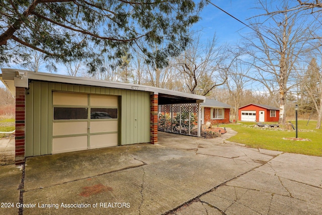 view of front of house with a garage, a front lawn, and a carport