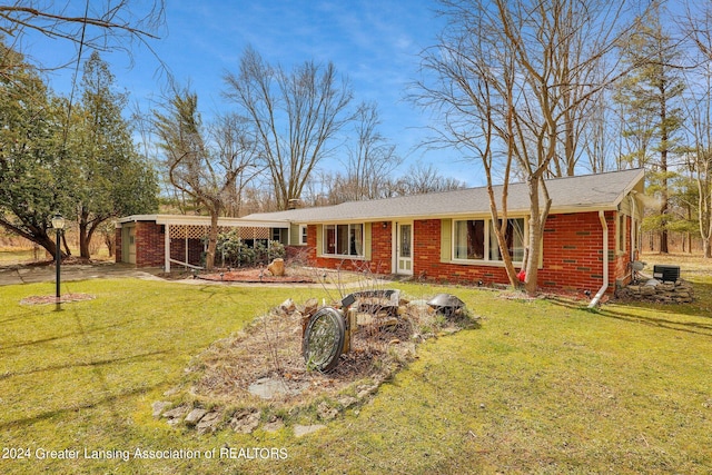 view of front of home featuring a front lawn and central air condition unit