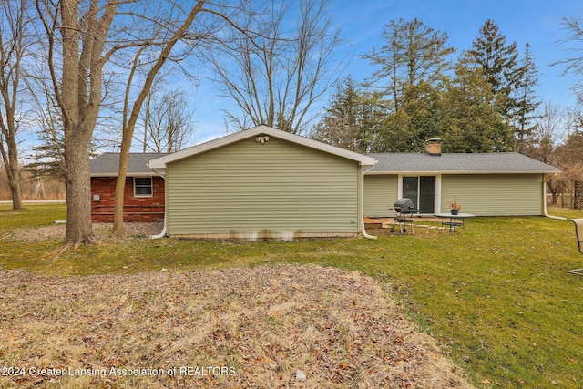 back of house with a yard