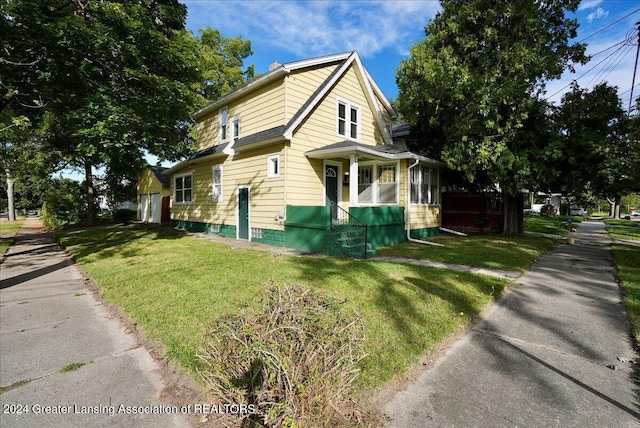 view of home's exterior with a lawn