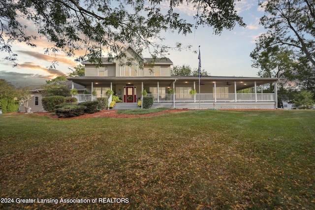 view of front of property with a lawn and a porch