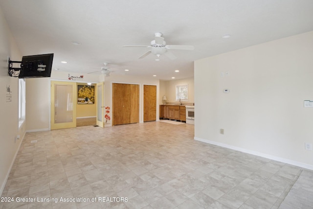 spare room featuring sink and ceiling fan