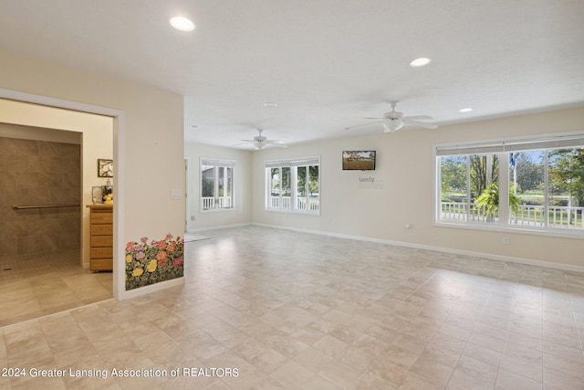 unfurnished room with ceiling fan and a healthy amount of sunlight