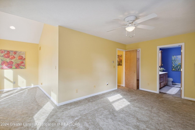 carpeted spare room with ceiling fan